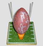 Autographed American Football on a wooden football field